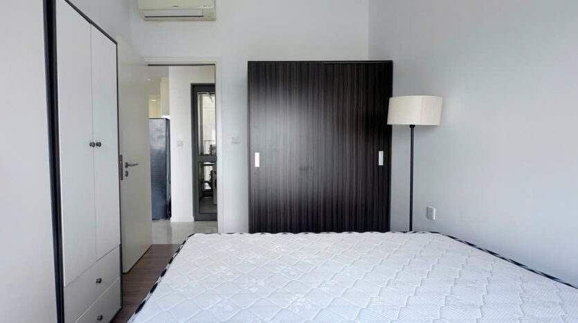 Second bedroom interior with floor lamp and view at Masteri An Phu Tower B apartment