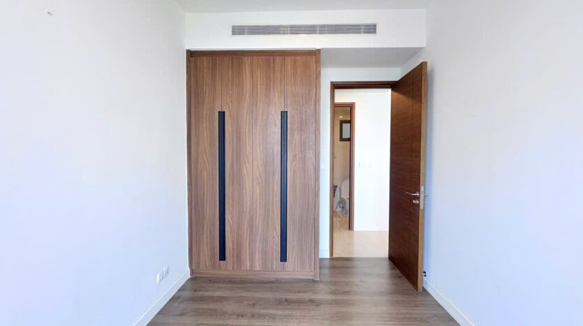Spacious bedroom with built-in wardrobe and ensuite at The Nassim Tower A apartment