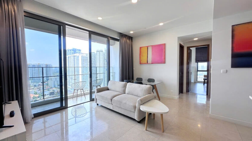 Master bedroom with green pillows and city view at The Nassim Tower A apartment