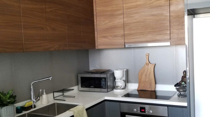 Spacious bedroom with wood floor at The Nassim Tower A apartment