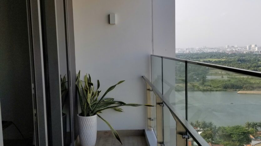 Balcony with glass railing and Saigon River view at The Nassim Tower A apartment