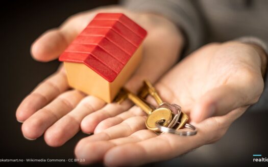 Hands holding a house model and keys | Bàn tay cầm mô hình nhà và chìa khoá